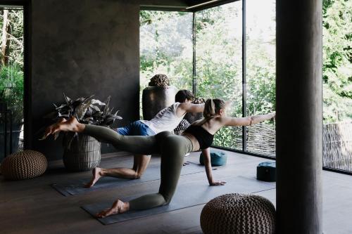 a group of people doing yoga in a room at Boutique Hotel Haidachhof superior in Fügen