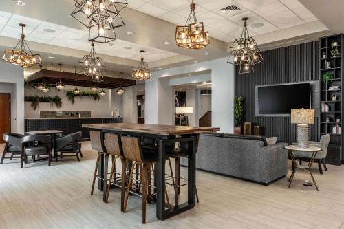 a lobby with a bar and a couch at Drury Plaza Hotel College Station in College Station