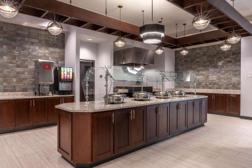 a large kitchen with a large counter with pots and pans at Drury Plaza Hotel College Station in College Station