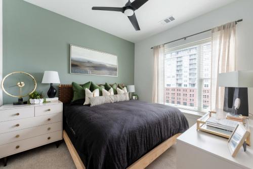 a bedroom with a bed and a dresser and a window at Jade Junction in Atlanta