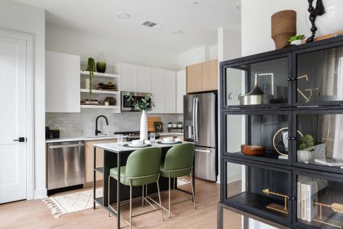 a kitchen with a table and some green chairs at Jade Junction in Atlanta