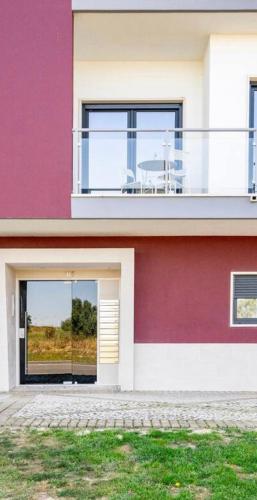 a house with a balcony with a table on it at Modern Big Room with Balcony in New Apartment in Montijo
