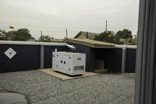 a air conditioner sitting on top of a roof at Grace On Wallstreet Apartments in Otta