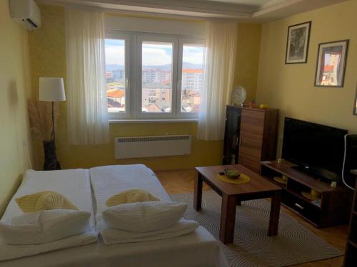 a living room with a couch and a table at ANNI apartman in Paraćin