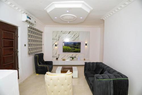 a living room with a couch and a table at Grace On Wallstreet Apartments in Otta