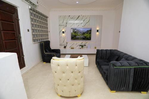 a living room with a couch and a table at Grace On Wallstreet Apartments in Otta