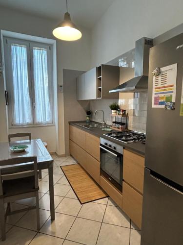 a kitchen with a table and a stove top oven at Casa MaKiGiò in Vietri sul Mare