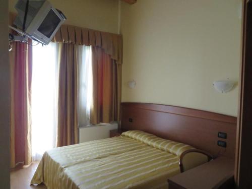 Postel nebo postele na pokoji v ubytování Ristorante Albergo Wada