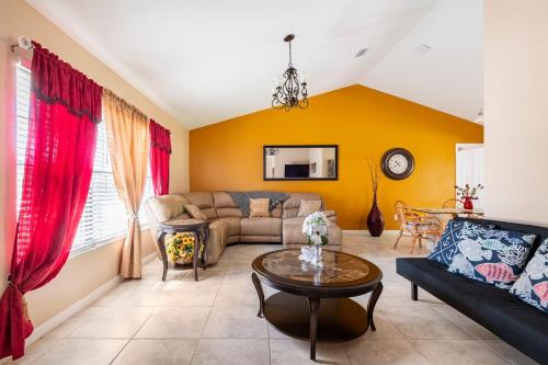 a living room with a couch and a table at paradise vacation luxury home in Palm Bay