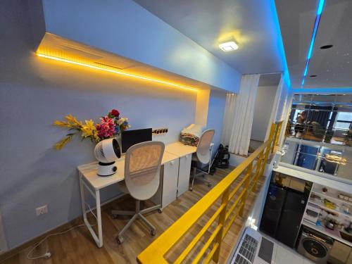 a salon with a desk and chairs in a room at StarSuiteAC at Arte Cheras with Soundproof Karaoke, Billiard, Air-Hockey in Kuala Lumpur