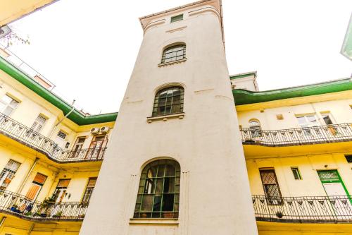 a tall white tower in front of a building at 2 bedrooms and 1 living room Your modern home in Budapest in Budapest