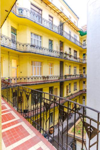 an external view of a yellow building with balconies at 2 bedrooms and 1 living room Your modern home in Budapest in Budapest