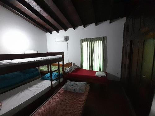 a bedroom with two bunk beds and a window at Quintana in Asunción