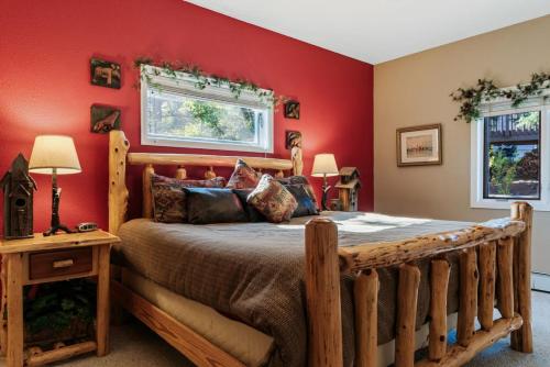 a bedroom with a wooden bed with red walls at Warm Mountain Escape Secluded Peaceful Hot Tub in Bordenville