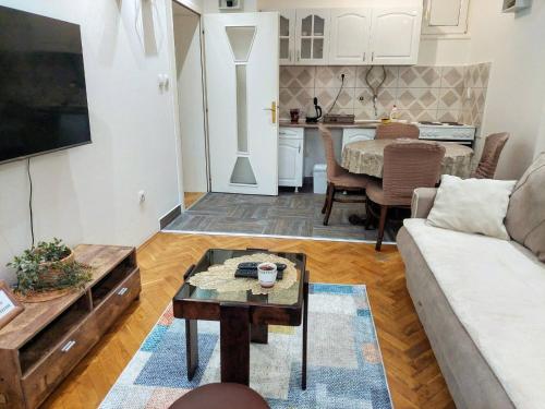 a living room with a couch and a table at Stan na dan Alexa sa free parkingom in Novi Sad