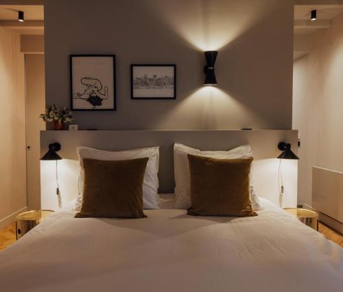 a bedroom with a white bed with two pillows at Suite no 7, hidden gem center of Amsterdam in Amsterdam