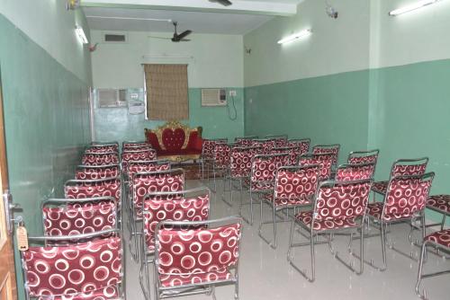a room with a bunch of red chairs in a room at Hotel Naveen Residency in Darbhanga