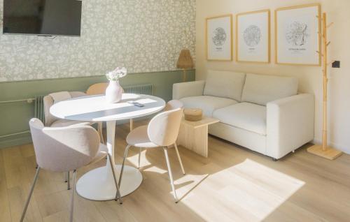 a living room with a couch and a table and chairs at Le Gabriel in Strasbourg