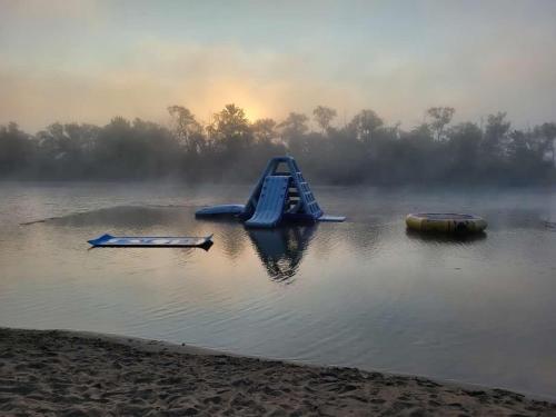 a playground in the middle of a lake with a slide at Wildwood Bunkies in Bailieboro