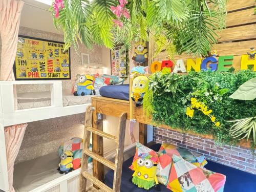 a room with bunk beds and plants at Hotel Orange House in Osaka