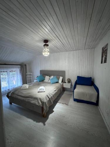 a bedroom with a large bed and a window at House Beskyd in Skole