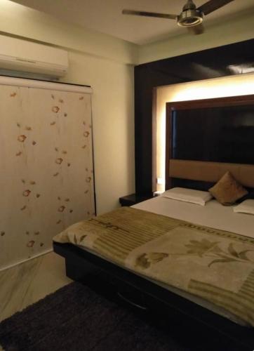a bedroom with a large bed and a ceiling at The luxe Aravali in Udaipur