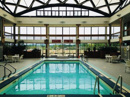 a swimming pool in a building with a large window at Holiday Inn & Suites Pittsfield-Berkshires by IHG in Pittsfield