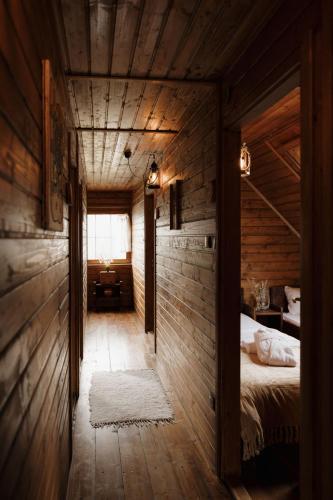a bedroom with a bed in a wooden room at Wild&Free Private Lake in Nagycsepely