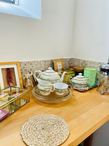 a wooden table with a bunch of dishes on it at Belle Fontaine in Bourges