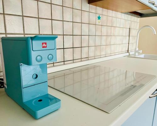 a machine sitting on top of a kitchen counter at Elena's apartment in Cannigione