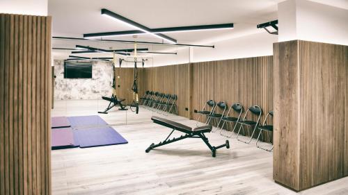 a gym with blue mats and chairs in a room at Berg-Leben in Grossarl