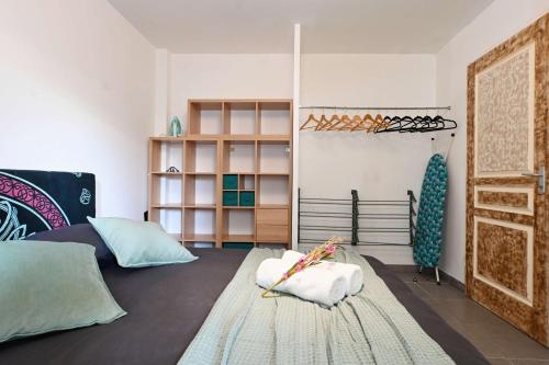 a room with two beds and a rug at Appt T2 en rez-de-jardin, au calme, à 2mn tram ! in Castelnau-le-Lez