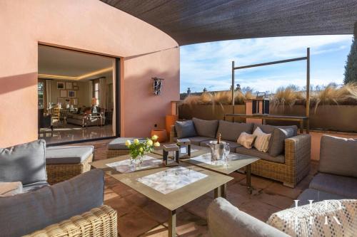 un patio avec un canapé, une table et des chaises dans l'établissement Superbe appartement de haut standing, à Saint-Tropez