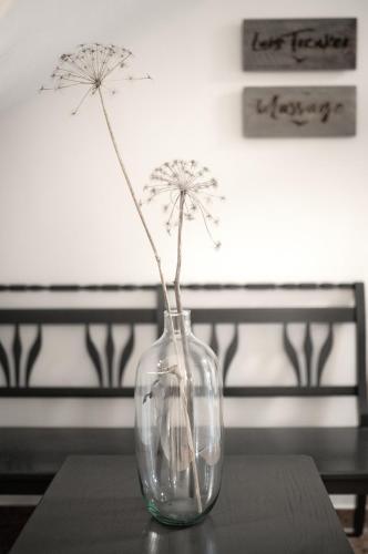 a glass vase with dandelions in it on a table at Berg-Leben in Grossarl