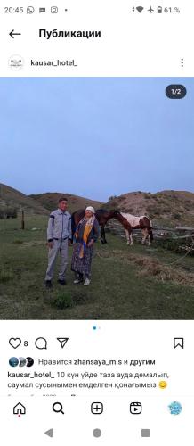 a man and a woman standing next to a horse at kausar hotel in Klyuchi