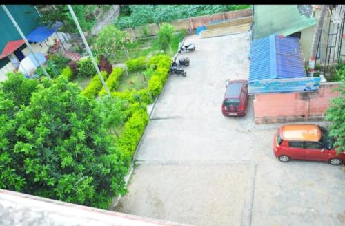 two cars are parked in a parking lot at vishnuregencybelur in Belūr