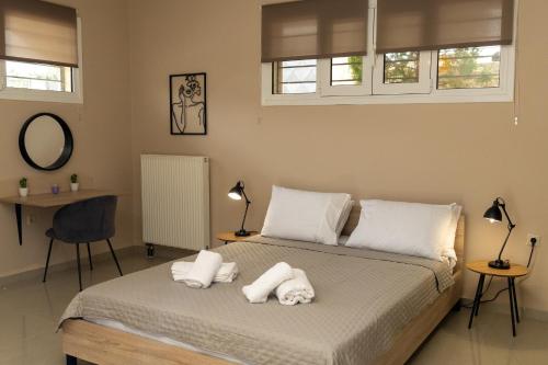een slaapkamer met een bed met handdoeken erop bij Dream Villa in Kokkíni Khánion