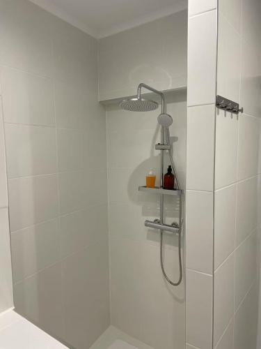 a bathroom with a shower with a shower head at Casalondres emTR77 in Lisbon