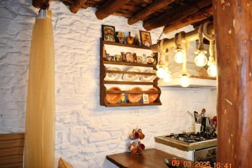a kitchen with a stone wall and a stove at Mannas House 2 in Émbonas