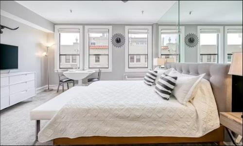 a bedroom with a large white bed with pillows at Palm Beach Modern Condo-Beach Attractions Nearby in Palm Beach