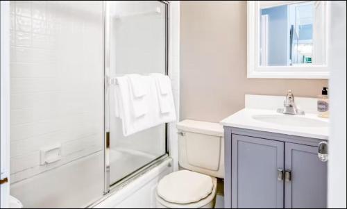a bathroom with a shower and a toilet and a sink at Palm Beach Modern Condo-Beach Attractions Nearby in Palm Beach