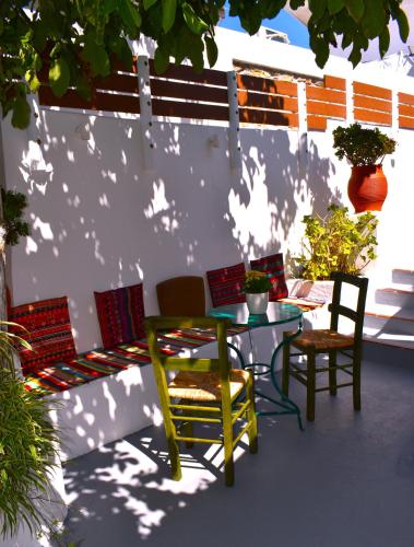 a patio with chairs and a table and chairs at Mannas House 2 in Émbonas