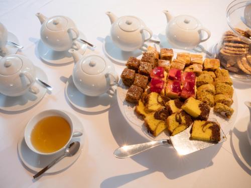 a table with a plate of food and a cup of tea at Hotel Cristallo in Solda