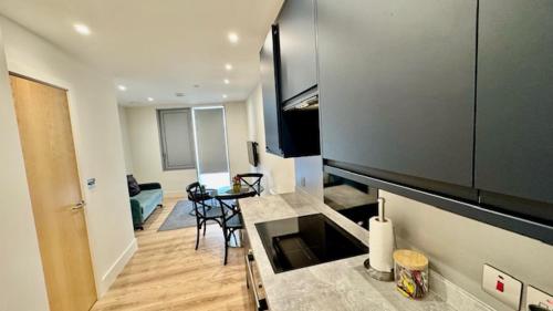 a room with a kitchen and a living room at Stratford Apartments in London