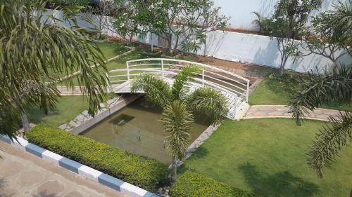 an overhead view of a garden with a white bridge at Mrugavani Resort & Spa in Hyderabad