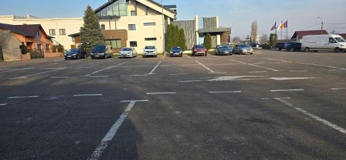 a parking lot with several cars parked in it at Hotel Coroana in Tîrgu Frumos