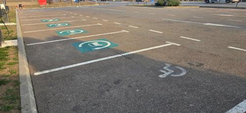 an empty parking lot with handicapped signs on the road at Hotel Coroana in Tîrgu Frumos