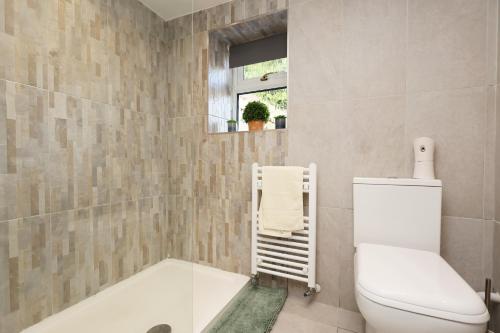 a bathroom with a toilet and a bath tub at Cottage in Nantgarw 20 mins from Brecon in Nantgarw