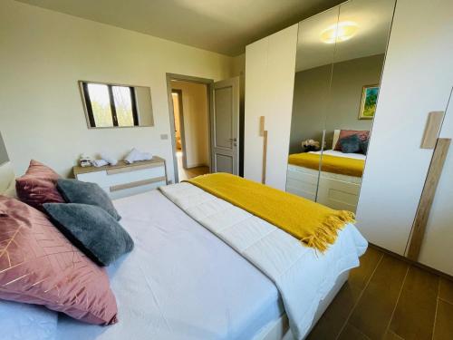 a bedroom with a bed with a large mirror at Holiday Flat in Villa San Gregorio with pool in Melazzo