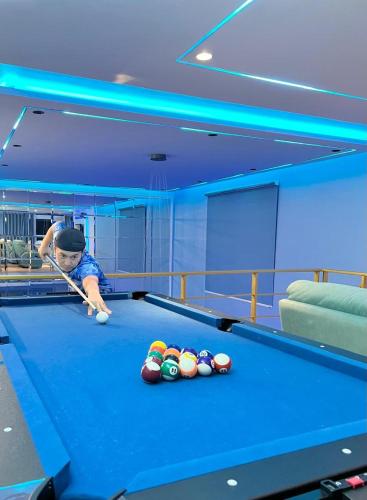 a young boy playing billiard in a pool table at StarSuiteAC at Arte Cheras with Soundproof Karaoke, Billiard, Air-Hockey in Kuala Lumpur